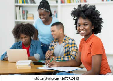 African American Female Computer Science Student With Group Of Students At Classroom Of University