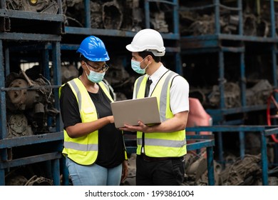 African American Female Employee Worker And Hispanic Man Manager Working Together At Old Auto And Car Parts Warehouse Store. People Wearing Face Mask Prevent Covid-19 Virus