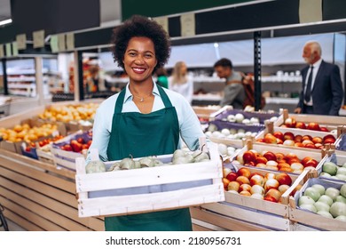 African American female employee working in grocery store. - Powered by Shutterstock