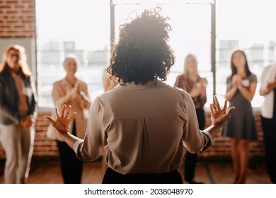 African american female empowering other colleagues in workplace