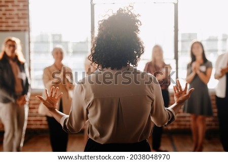 African american female empowering other colleagues in workplace