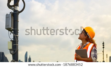 African American female engineer was checking the readiness of a communication tower.