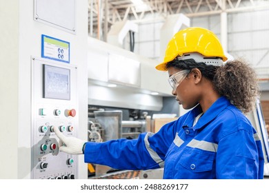 African american female engineer, paper factory worker wearing safety helmet in the automotive part warehouse. Factory workers check and control operate cardboard machines in paper manufacture. - Powered by Shutterstock