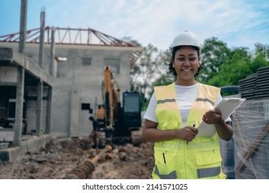 An African American female engineer is working manager on a project under construction for a house.A beautiful woman with black skin was smiling confidently. Wear personal protective equipment,PPE. - Powered by Shutterstock