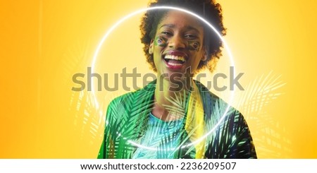 African american female fan with brazilian flag and face paint by illuminated plants and circle. Copy space, composite, sport, competition, soccer, shape, happy, cheering, match, nature, patriotism.