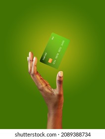 African american female hand and levitating template mockup Bank credit card with online service on green background - Shutterstock ID 2089388734