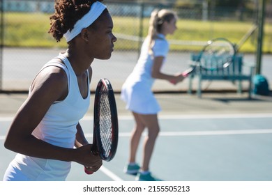 African american female player playing tennis game with caucasian doubles partner at court. unaltered, sport, competition and tennis game concept. - Powered by Shutterstock