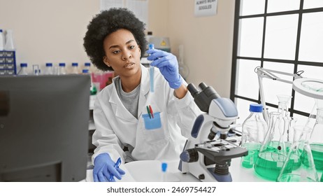 African american female scientist examining a test tube in a modern laboratory setting with scientific equipment. - Powered by Shutterstock