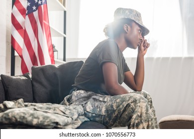 African american female soldier sitting on sofa