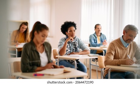 African American Female Student Paying Attention During Lecture In The Classroom. 