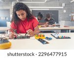 African American female teenager Student working on electronics robotics in the technology course