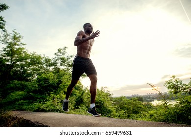 African american fitness handsome man training. Jogging against the morning sun. - Shutterstock ID 659499631