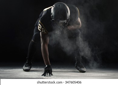 African American Football Player In A Three Points Stance.