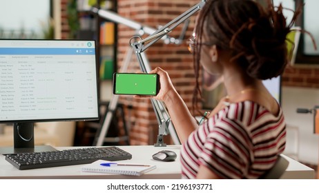 African American Freelancer Using Horizontal Greenscreen On Mobile Phone, Looking At Isolated Mockup Template With Chroma Key Background And Blank Copyspace. Holding Smartphone.