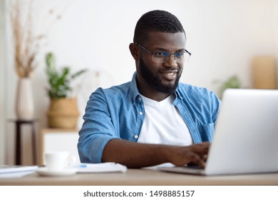 African american freelancer working on laptop at home.
