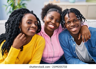 African American Friends Hugging Each Other Sitting On Sofa At Home