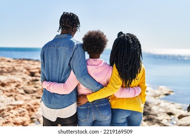 African American Friends Hugging Each Other On Back View At Seaside