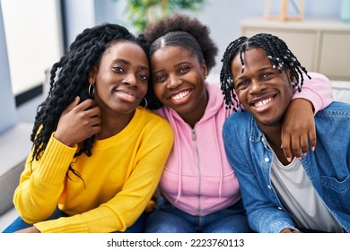 African American Friends Hugging Each Other Sitting On Sofa At Home