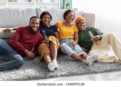 African American Friends Watching Movie At Home