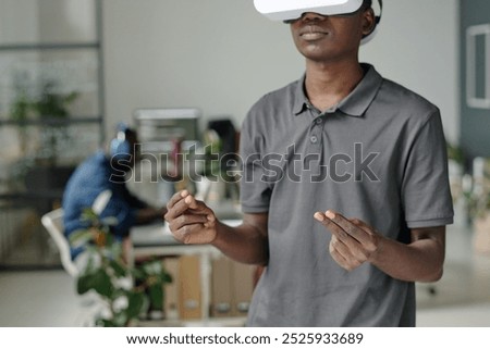 African American game developer gesticulating while enjoying VR game