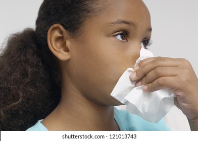 African American girl blowing her nose - Powered by Shutterstock