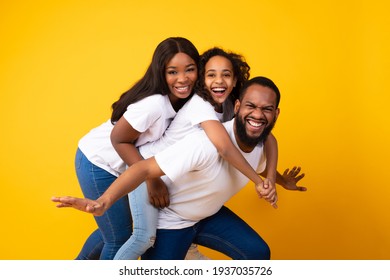 African American Girl Laughing With Her Mom And Dad