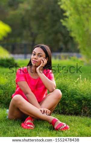 African american girl outdoor. Attractive dark skinned lady spend time Summer vacation in backyard. Candid portrait mixed race young black woman