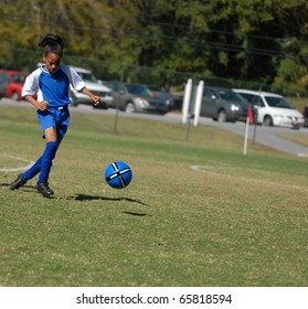 African American Girl Playing Soccer, With Focus On The Ball