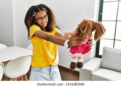 African American Girl Smiling Confident Holding Doll At Home
