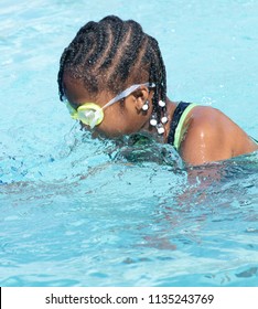 African American Girl Swimming In A Pool