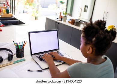 African American Girl Using Laptop While E-learning At Home, Copy Space. Unaltered, Domestic Life, Wireless Technology, Childhood, Digital Native And Education Concept.