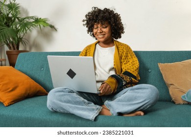 African American girl using laptop at home office typing chatting reading writing email. Young black woman having virtual meeting online chat video call conference. Work learning from home - Powered by Shutterstock