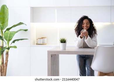 African American Girl using smartphone at home pressing finger, reading social media internet, typing text or shopping online Mobile phone in two black hands