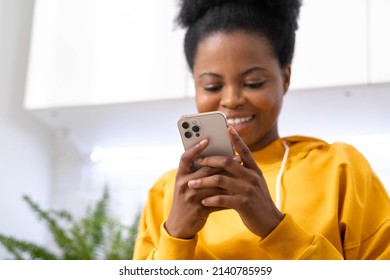 African American Girl using smartphone pressing finger, reading social media internet, typing text or shopping online Mobile phone in two black hands 