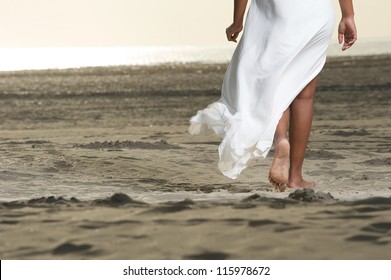 African American Girl Is Walking On The Beach Close Up On Feet