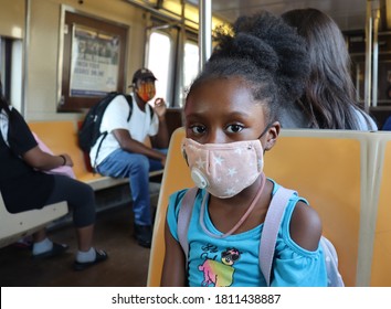 African American Girl Wearing Mask Sitting In Subway Car