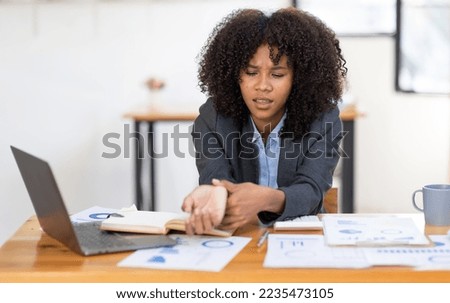 african american girl woman holding her wrist pain from using computer. Office syndrome hand pain by occupational disease.