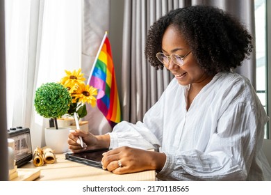 African American Girl Is Working At Home With LGBTQ Rainbow Flag In Her Table For Coming Out Of Closet And Pride Month Celebration To Promote Sexual Diversity And Equality Homosexual Orientation