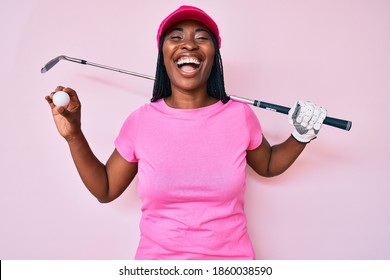 African american golfer woman with braids holding golf ball smiling and laughing hard out loud because funny crazy joke.  - Powered by Shutterstock