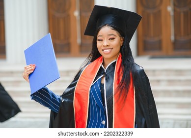 African American Graduate Holding Diploma.