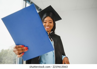 African American Graduate Holding Diploma.