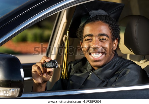 African American\
graduate with a new car