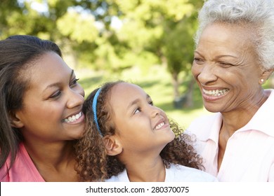 African American Grandmother, Mother And Daughter Relaxing In Park