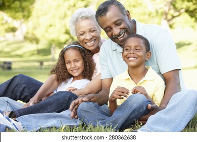 African American Grandparents With Grandchildren Relaxing In Park