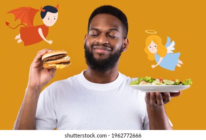 African American guy choosing between burger and vegetable salad, being torn between angel and devil on orange studio background, collage. Healthy vs unhealthy foods concept