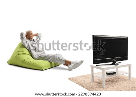African american guy sitting on a bean bag armchair and watching telly isolated on white background