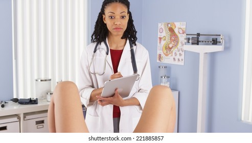 African American gynecologist examining patient
