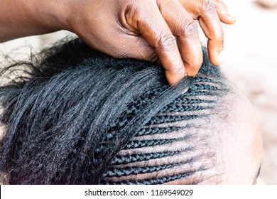 African American Hairdresser Coiffeur Weaves French Braids, Bride's Hairstyle. Professional Hair Stylist Makes Black Bride A Wedding Hairstyle For Beauty Salon And Professional Hair Care Concept