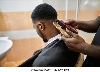 african american hairdresser cuts an african american man's hair with a clipper. clipper haircut - Shutterstock ID 2160748075