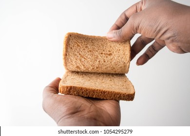 African American Hand Holding Two Slices Of Bread